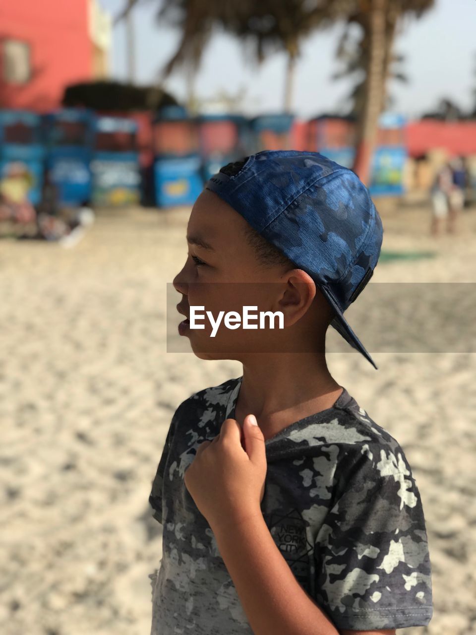 Close-up of boy standing at beach