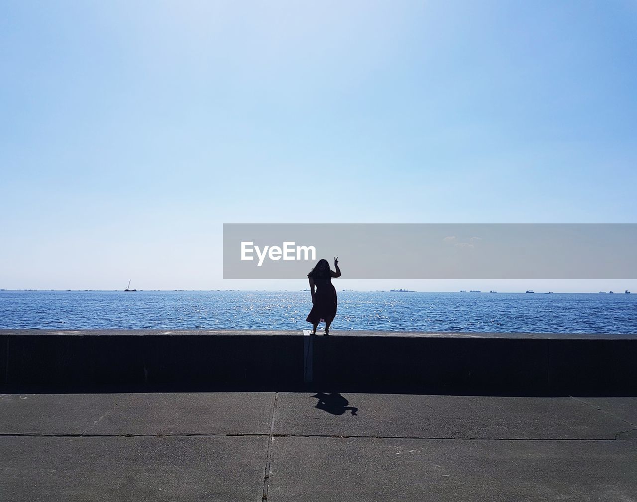 FULL LENGTH OF MAN ON SEA AGAINST SKY