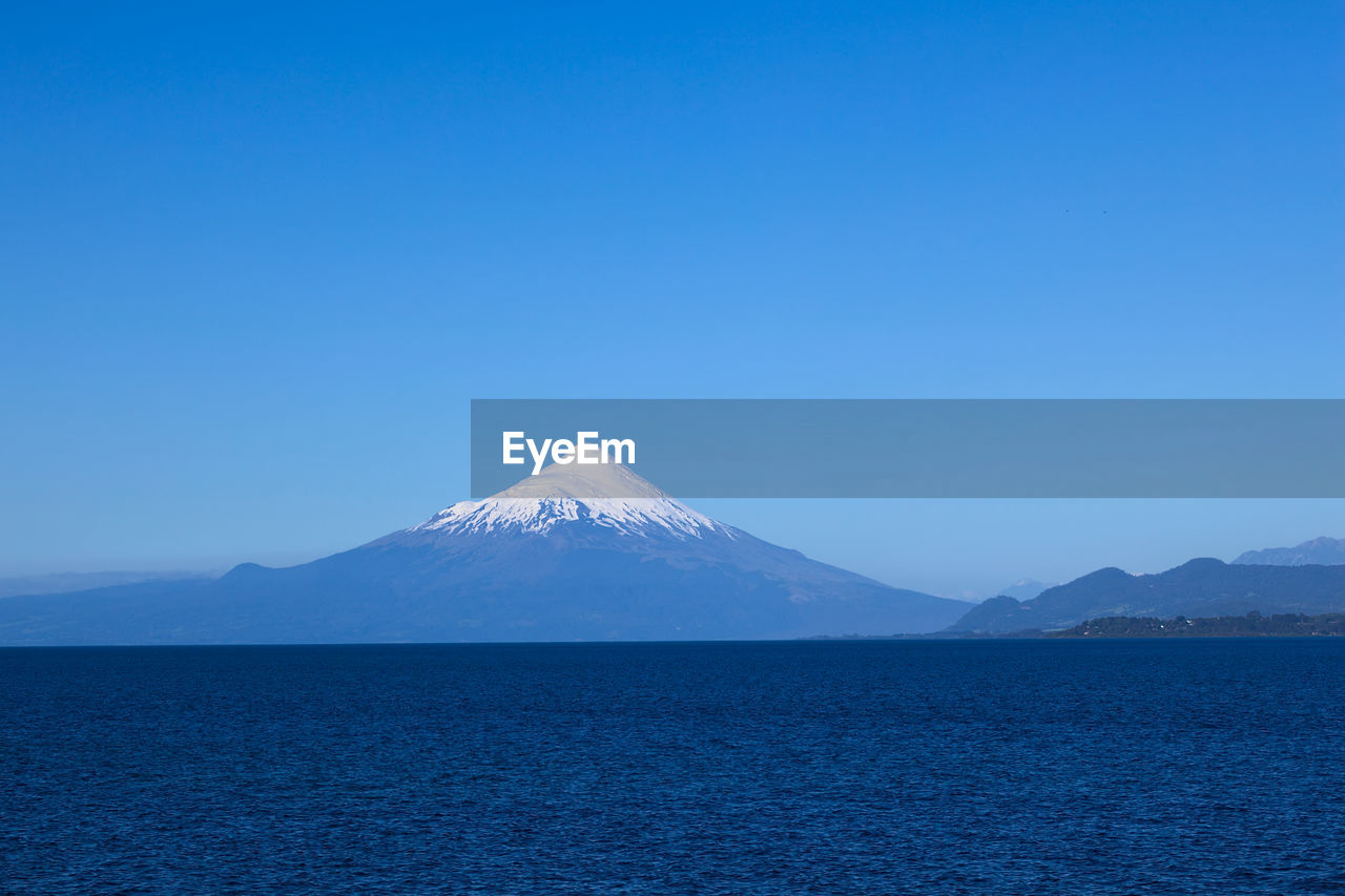 SCENIC VIEW OF MOUNTAIN AGAINST BLUE SKY