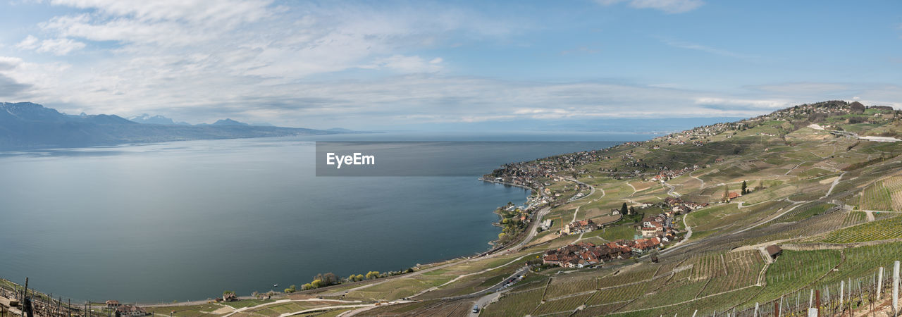 Panoramic view of sea and buildings against sky