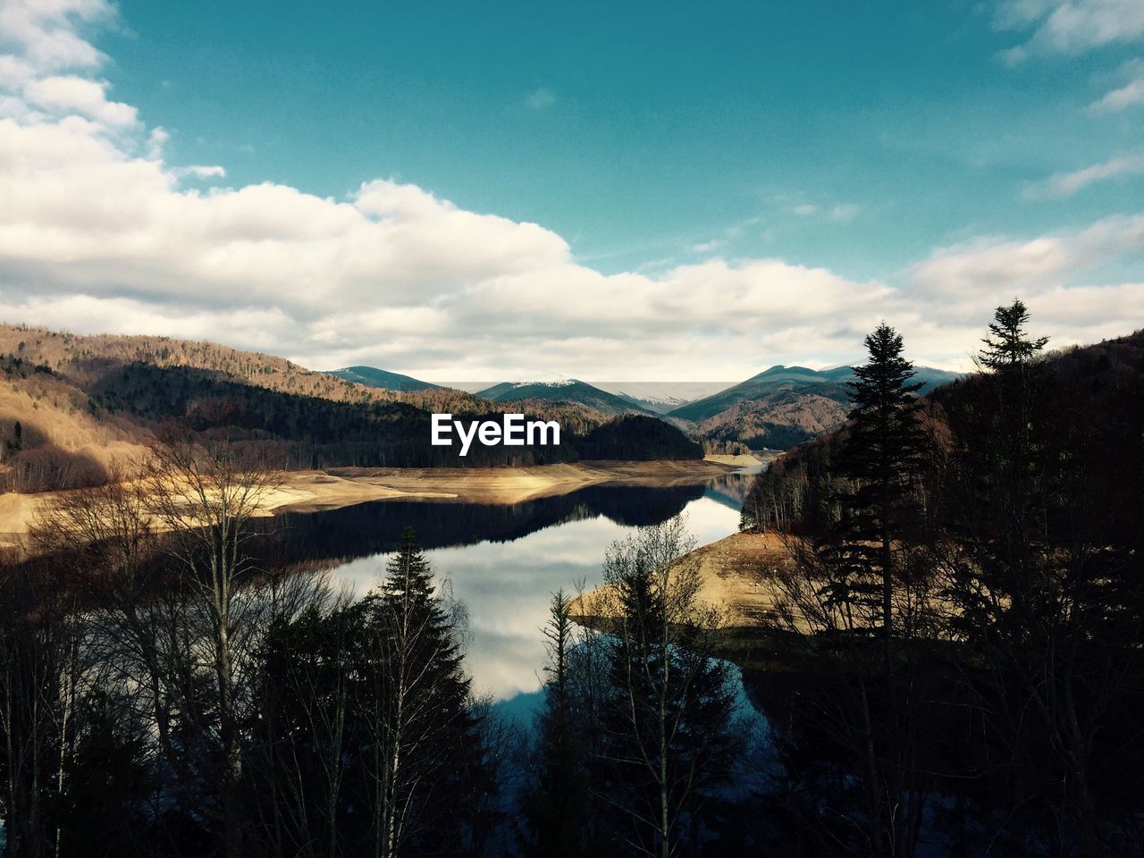 Scenic view of mountains against cloudy sky