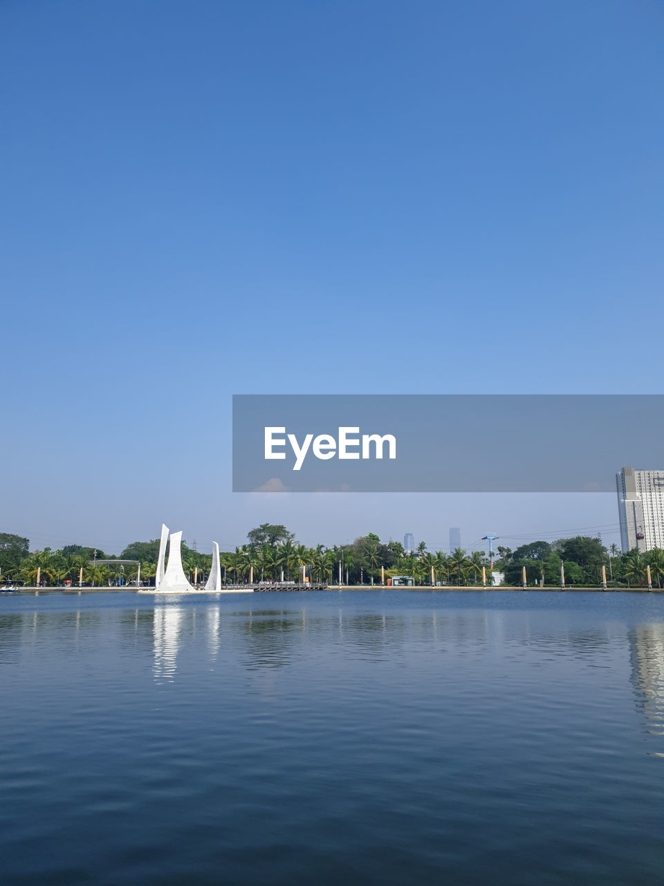 water, architecture, sky, built structure, blue, building exterior, reflection, nature, clear sky, travel destinations, sea, horizon, building, no people, city, copy space, travel, day, waterfront, outdoors, bay, tree, shore, tourism, reservoir, tranquility, plant, sunny, scenics - nature, environment, beauty in nature
