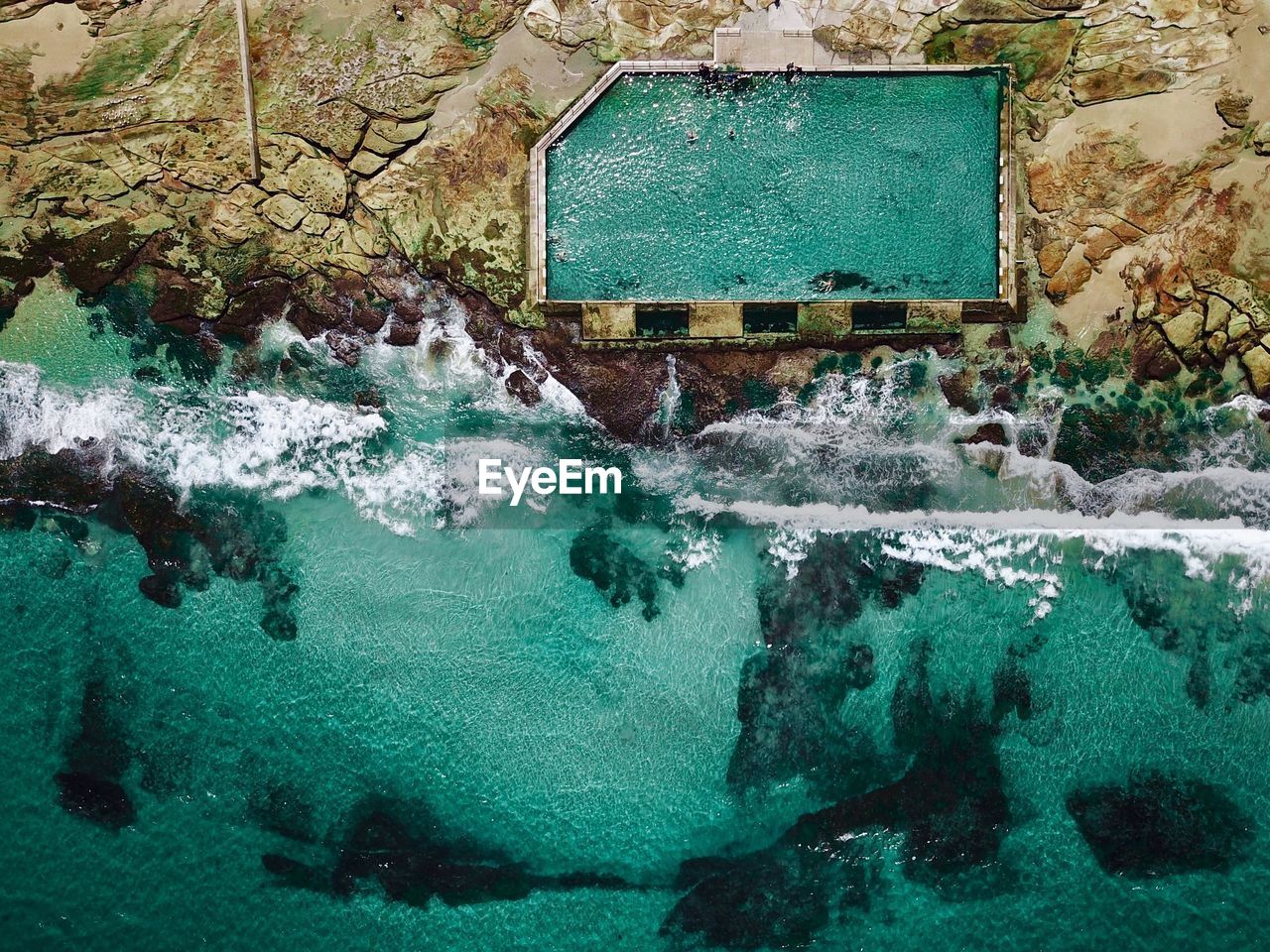 Aerial view of swimming pool by sea