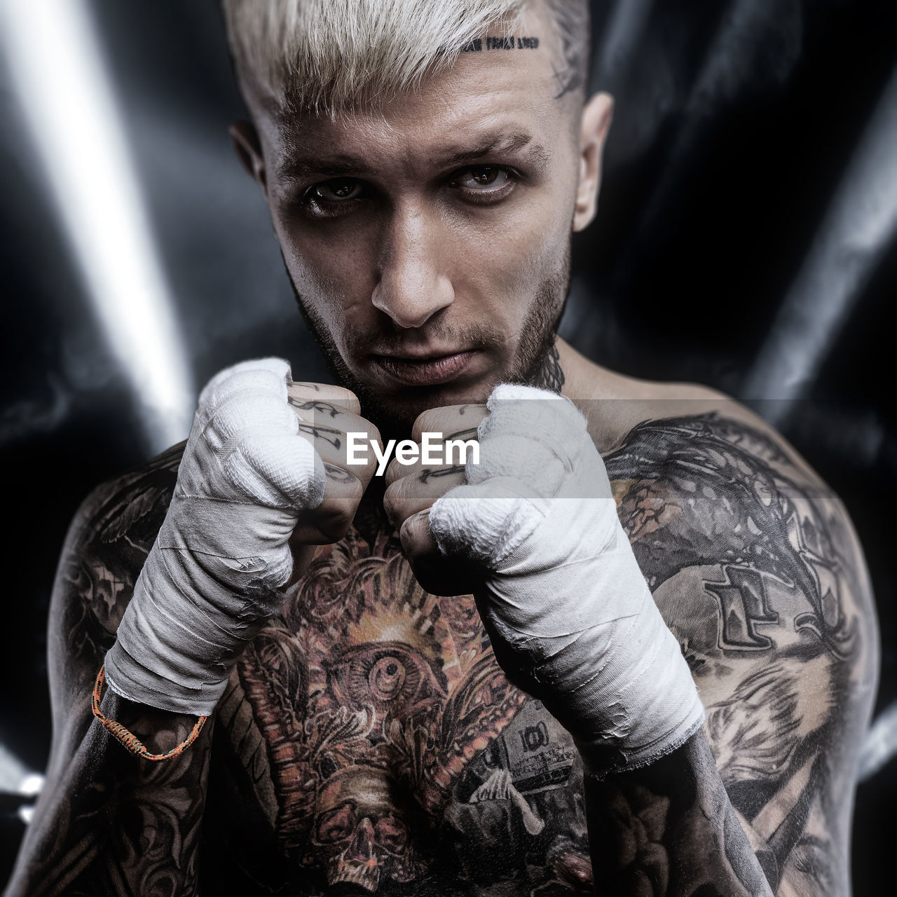 adult, one person, tattoo, portrait, boxing, men, sports, strength, boxing glove, muscular build, serious, young adult, conflict, lifestyles, anger, combat sport, looking at camera, athlete, fighting, exercising, individuality, indoors, toughness, determination, macho, black background, beard, activity