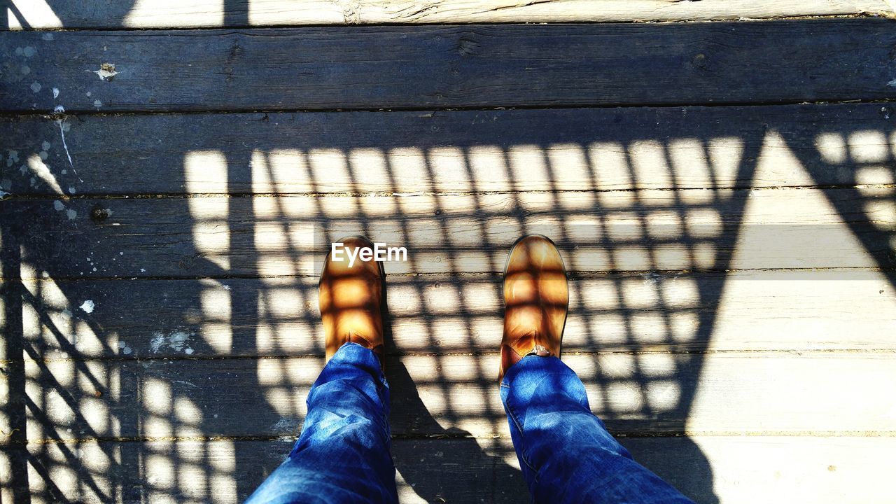 Low section of man standing on deck