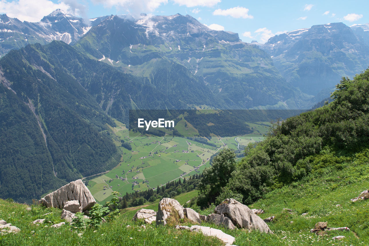 Scenic view of landscape and mountains against sky