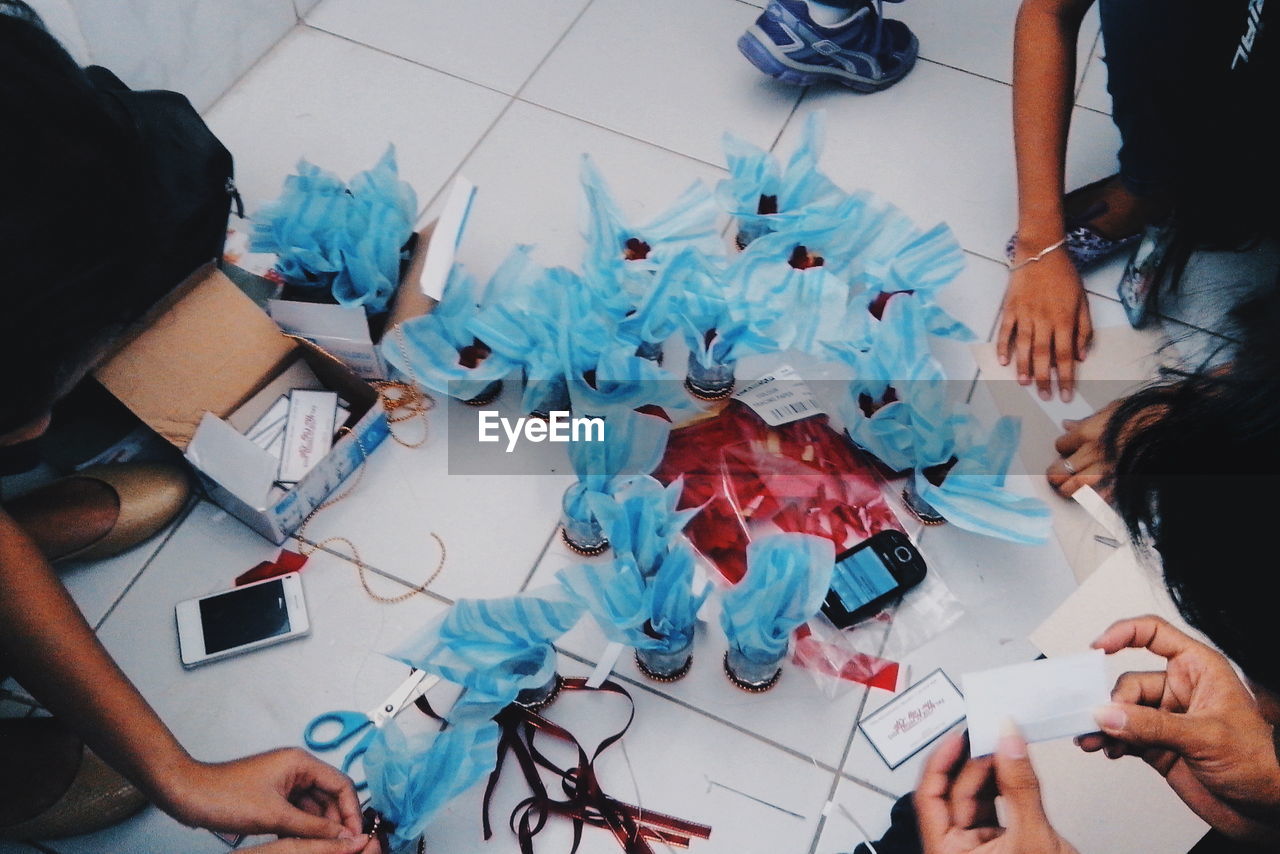 High angle view of people with artwork on floor