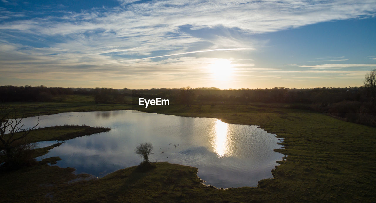 Scenic view of lake against sky during sunset