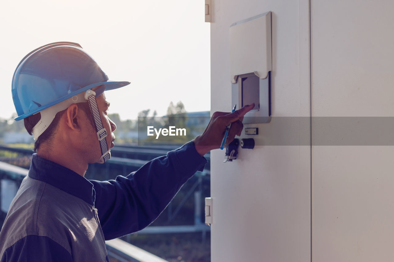 Male engineer checking meter