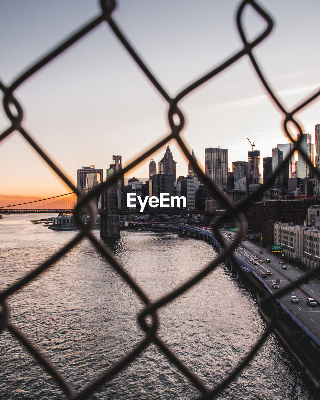 View of city seen through chainlink fence