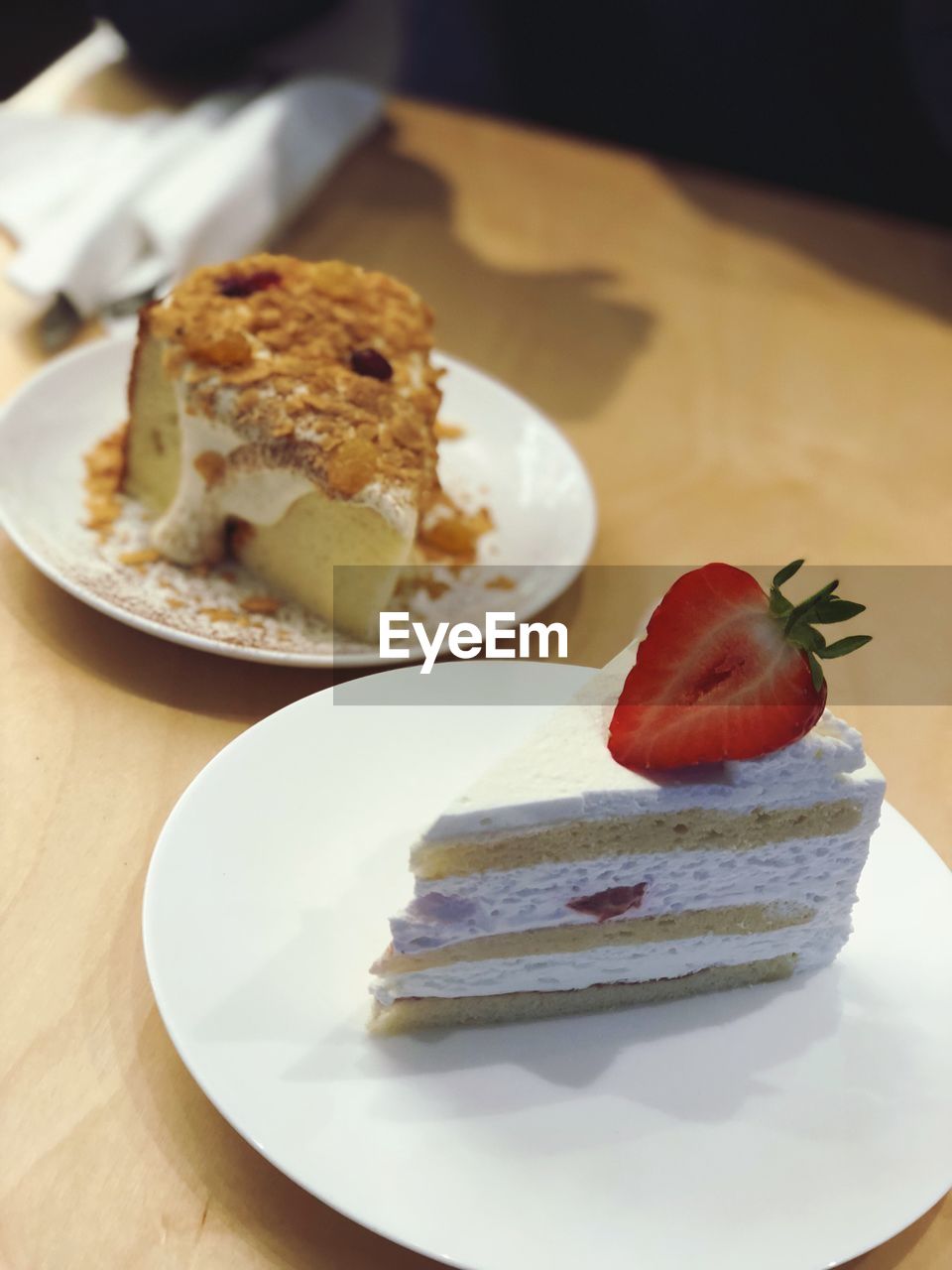 Cakes in plates on table