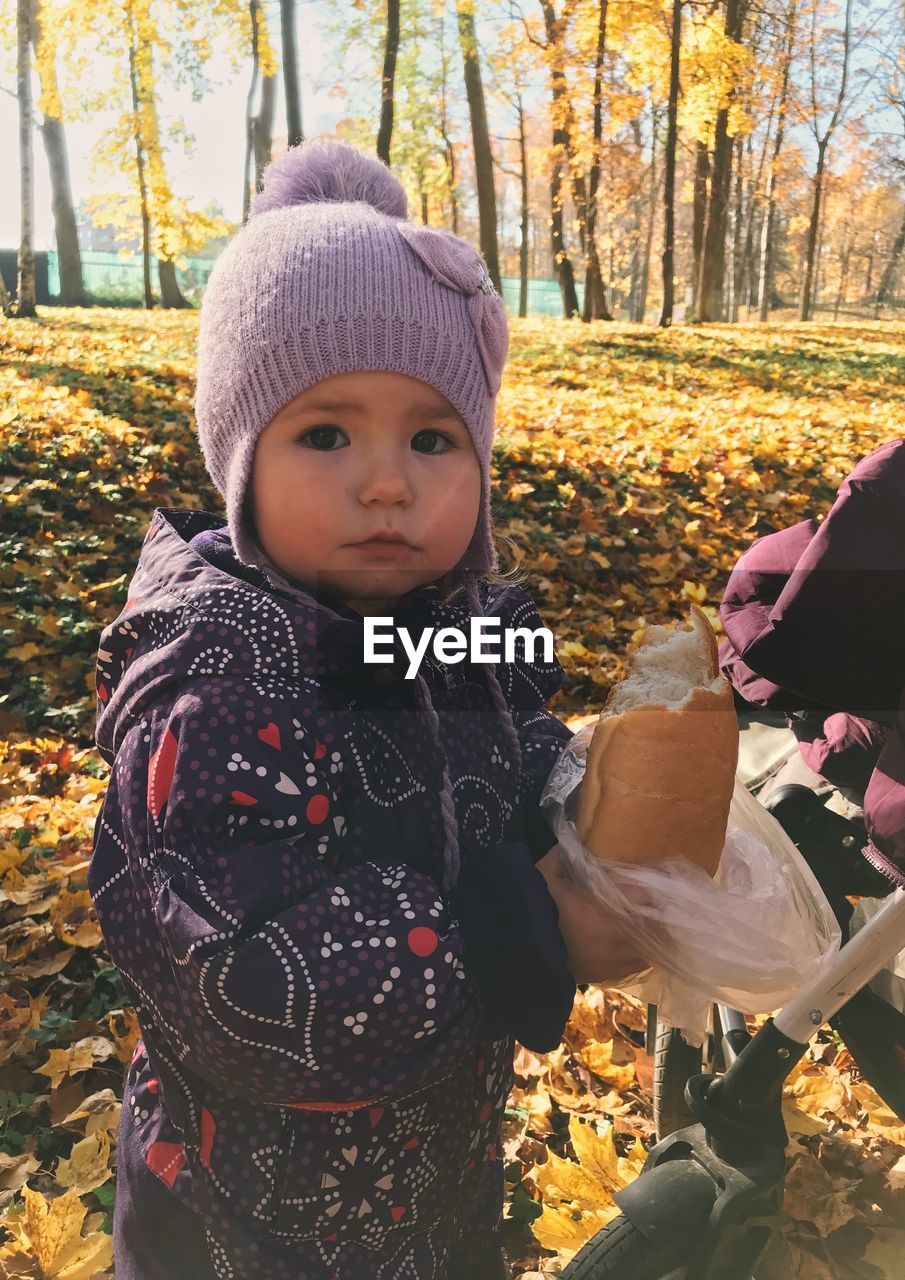 PORTRAIT OF CUTE BABY GIRL ON FIELD