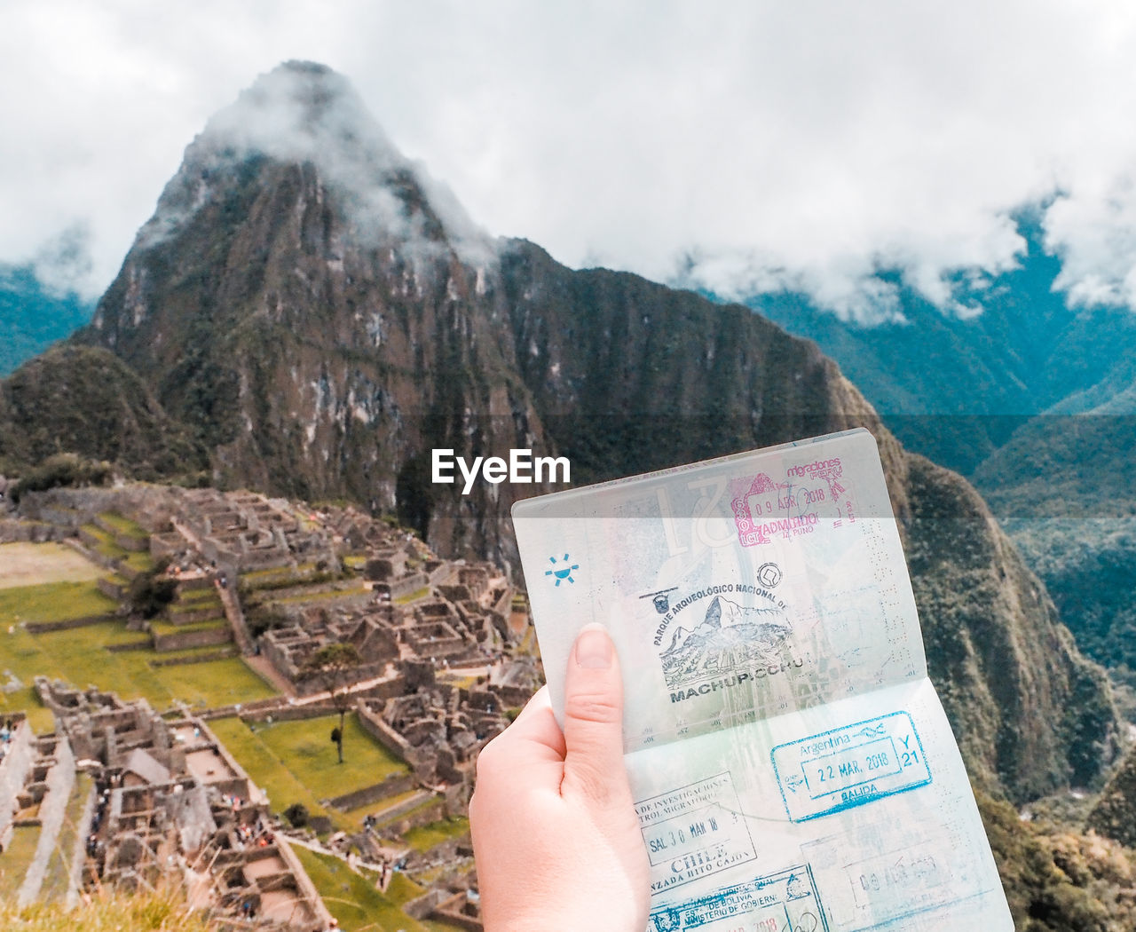 HUMAN HAND HOLDING MOUNTAIN