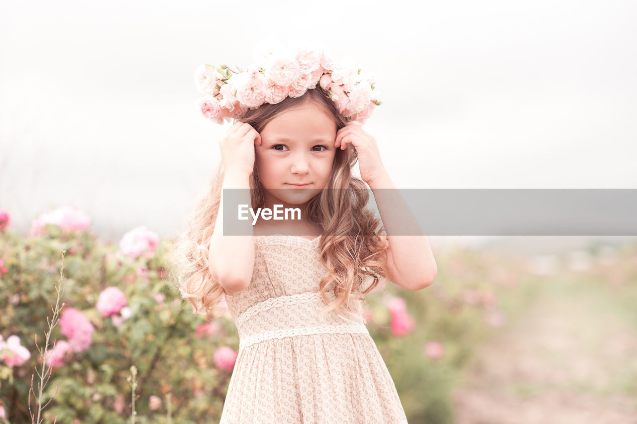 Portrait of girl standing on field