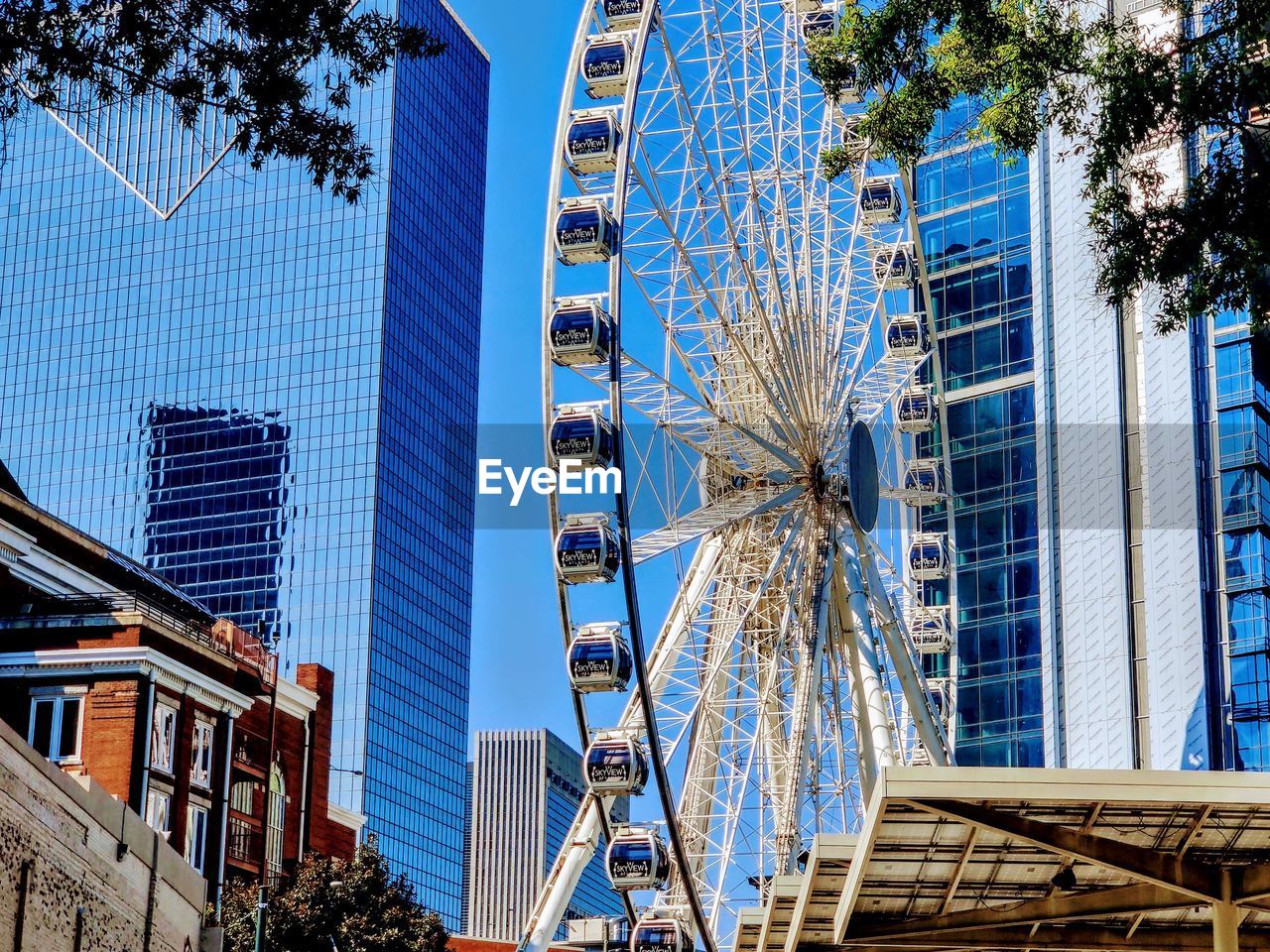 LOW ANGLE VIEW OF MODERN BUILDING AGAINST BLUE SKY