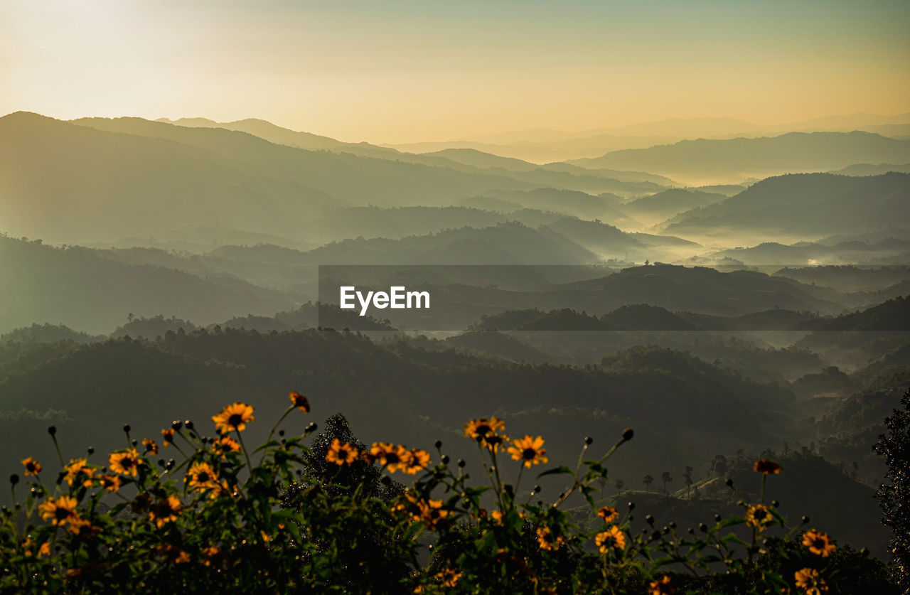 SCENIC VIEW OF ORANGE MOUNTAINS AGAINST SKY DURING SUNSET