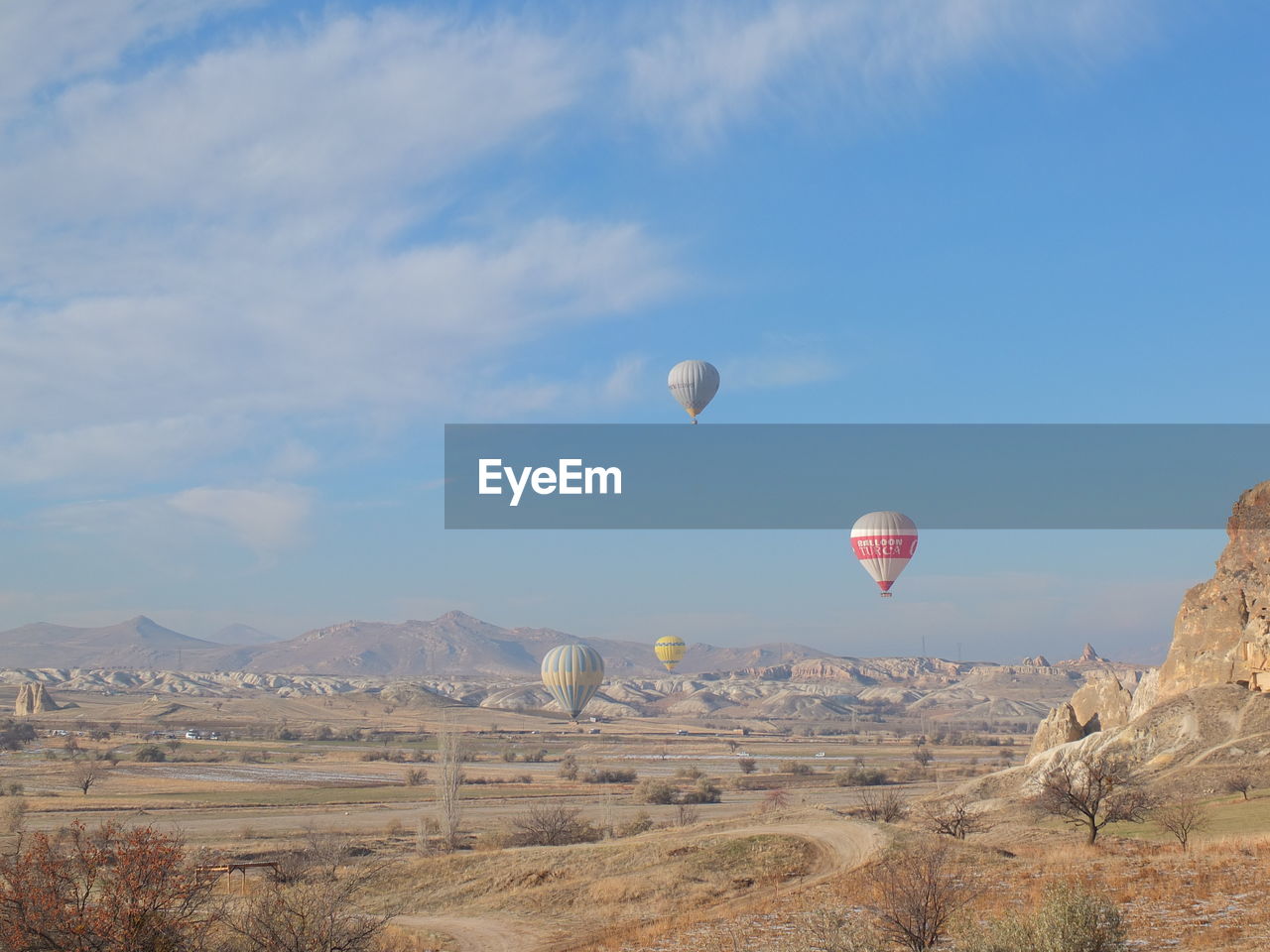 VIEW OF HOT AIR BALLOON FLYING OVER LANDSCAPE