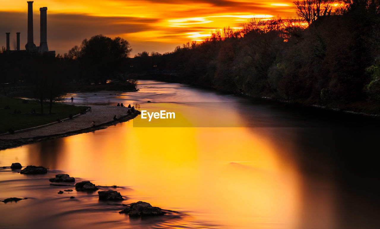 reflection, water, sunset, evening, sky, dawn, nature, tree, river, beauty in nature, orange color, plant, environment, scenics - nature, night, cloud, architecture, landscape, no people, tranquility, outdoors, land, built structure, afterglow, silhouette, travel destinations, industry, twilight, tranquil scene