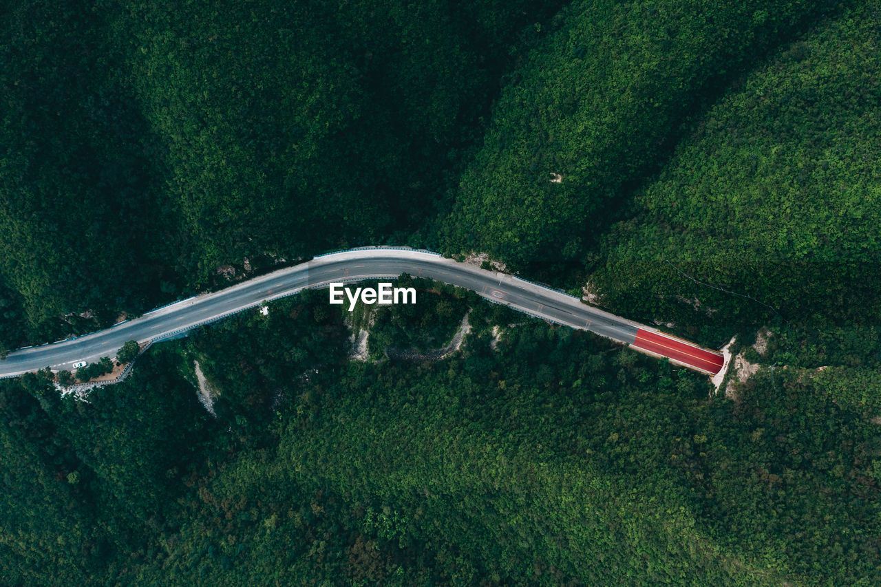 HIGH ANGLE VIEW OF ROAD AMIDST FIELD