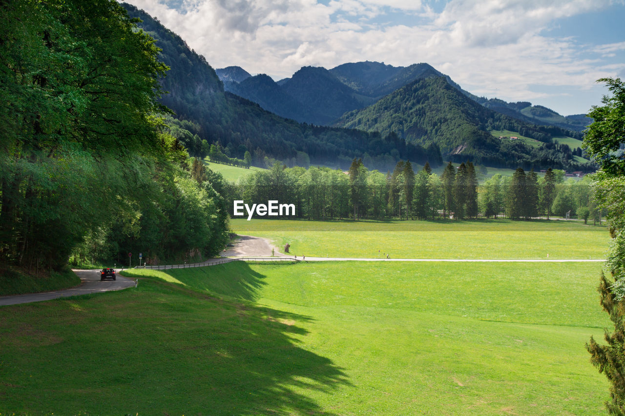 Scenic view of golf course against sky