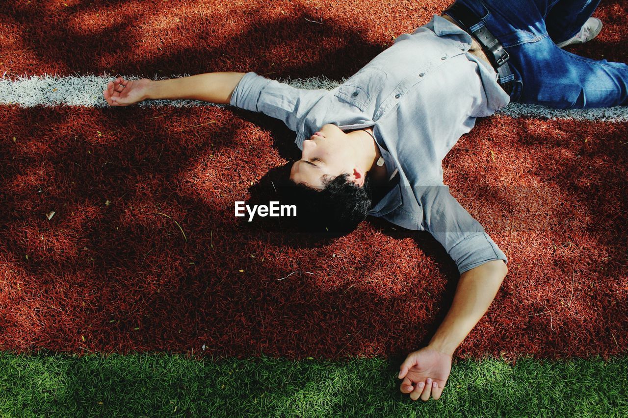 High angle view of man lying on grass