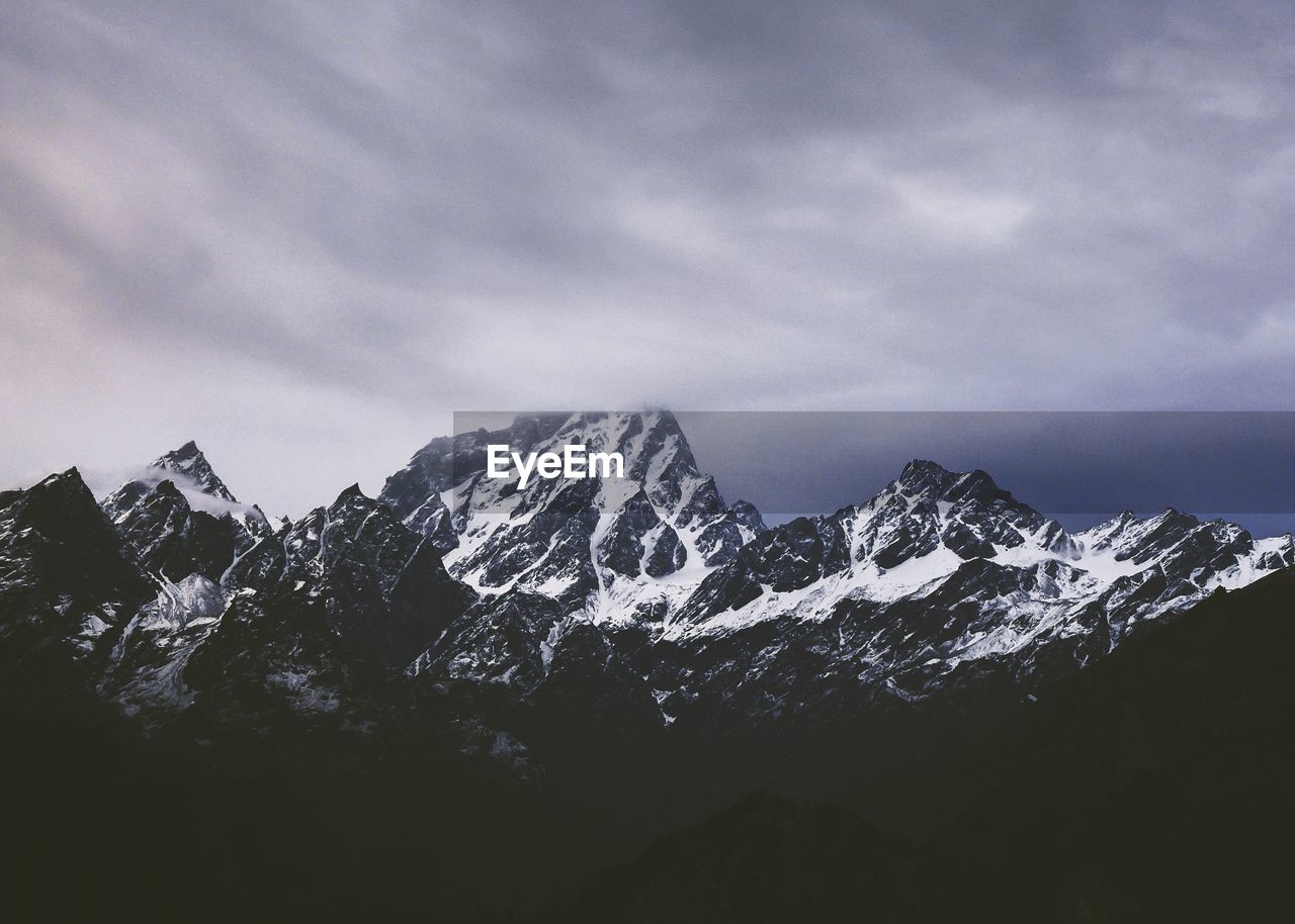 Scenic view of snowcapped mountains against sky