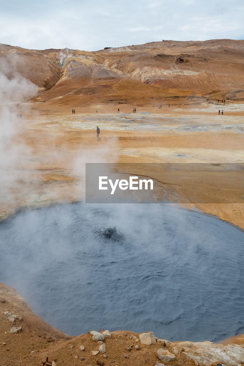 Scenic view of geyser against sky