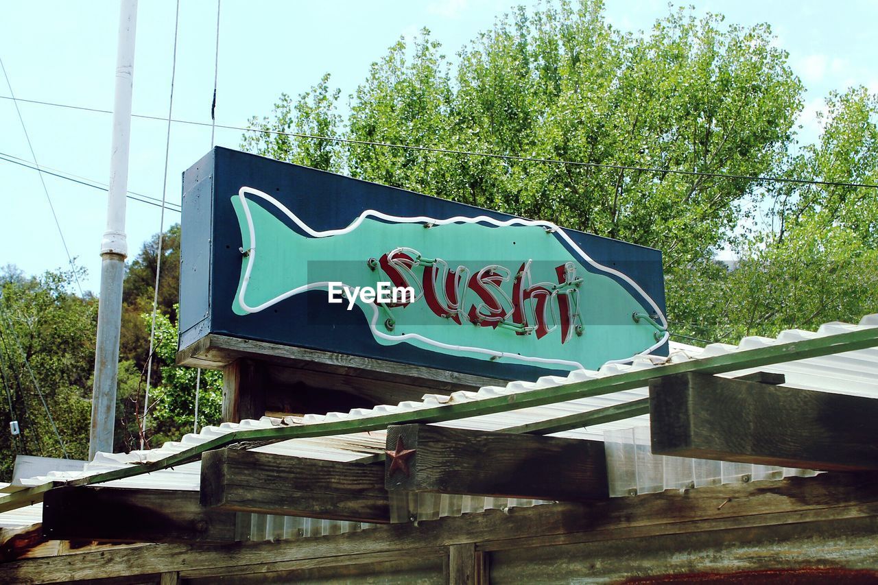 Low angle view of sushi sign board outside restaurant