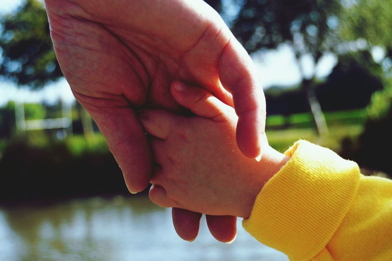 Extreme close up of holding hands