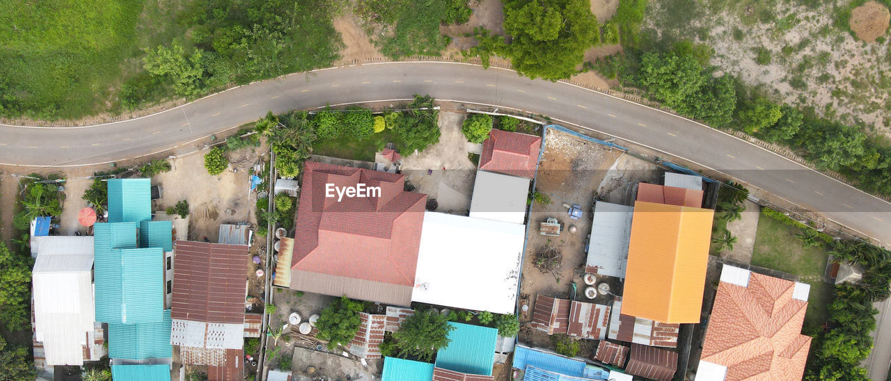 HIGH ANGLE VIEW OF BUILDINGS AND TREES SEEN THROUGH WINDOW