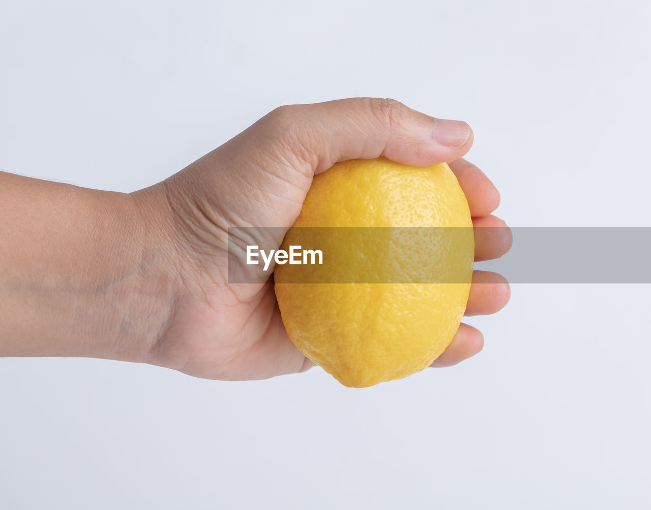 hand, lemon, citrus, fruit, citron, citrus fruit, food, food and drink, healthy eating, wellbeing, studio shot, produce, holding, freshness, orange, one person, plant, adult, yellow, indoors, white background, close-up, cut out, squeezing, orange color, single object, bitter orange, grapefruit