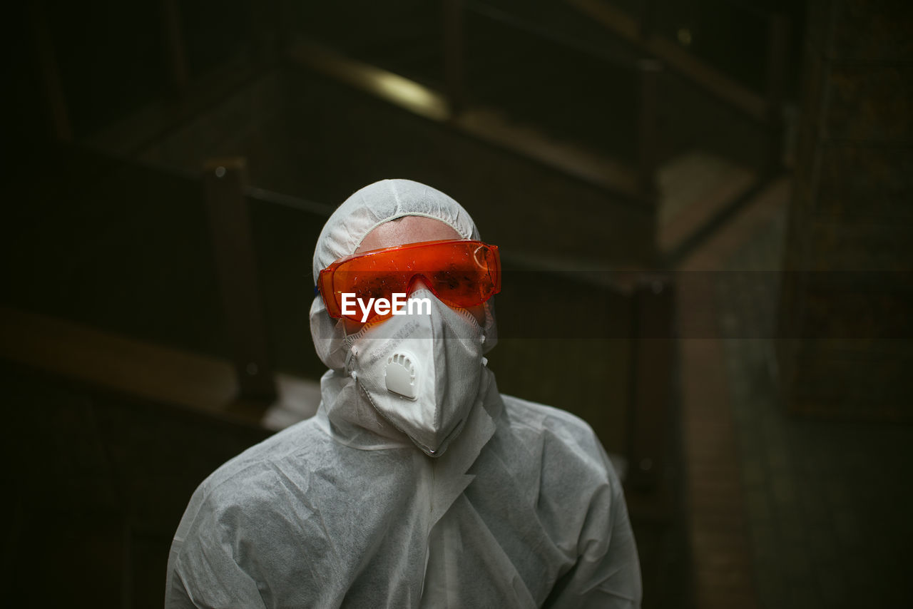 Portrait of man wearing protective goggles in laboratory