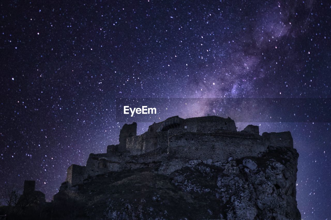 LOW ANGLE VIEW OF ROCKS AT NIGHT