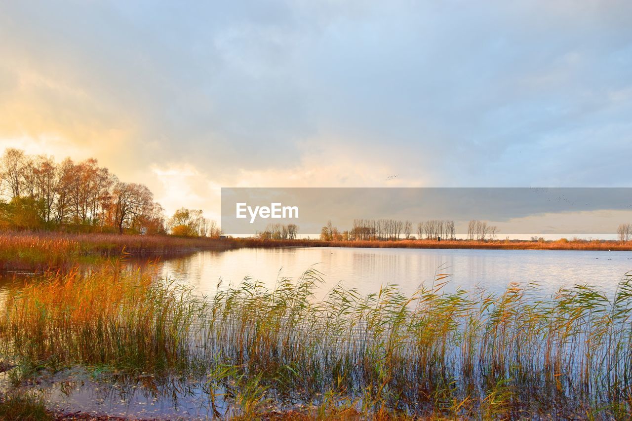 Scenic view of lake against cloudy sky