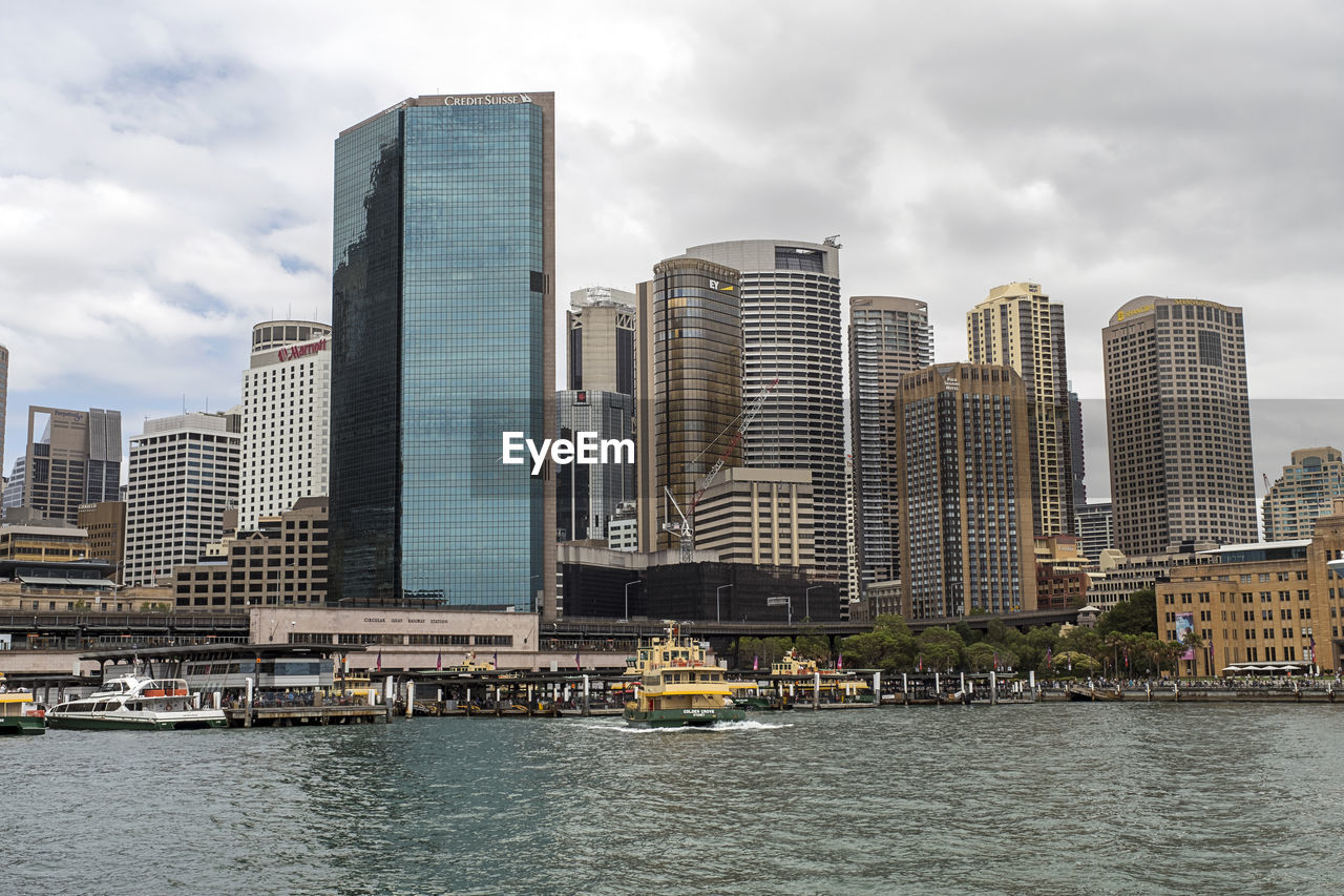 View of skyscrapers against cloudy sky