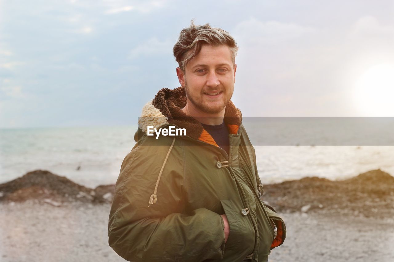 Portrait of man standing at beach