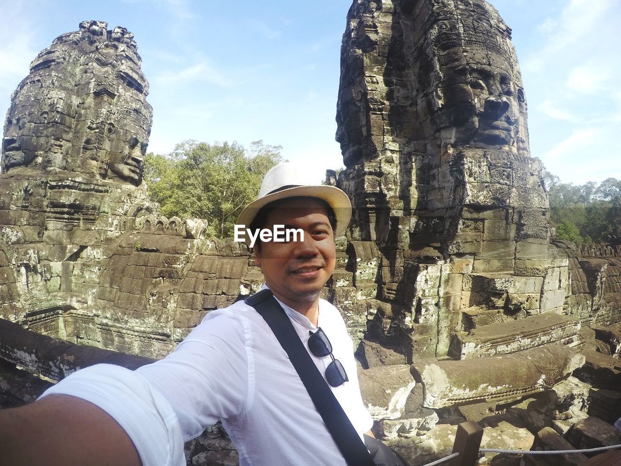 Portrait of young man standing at historic temple