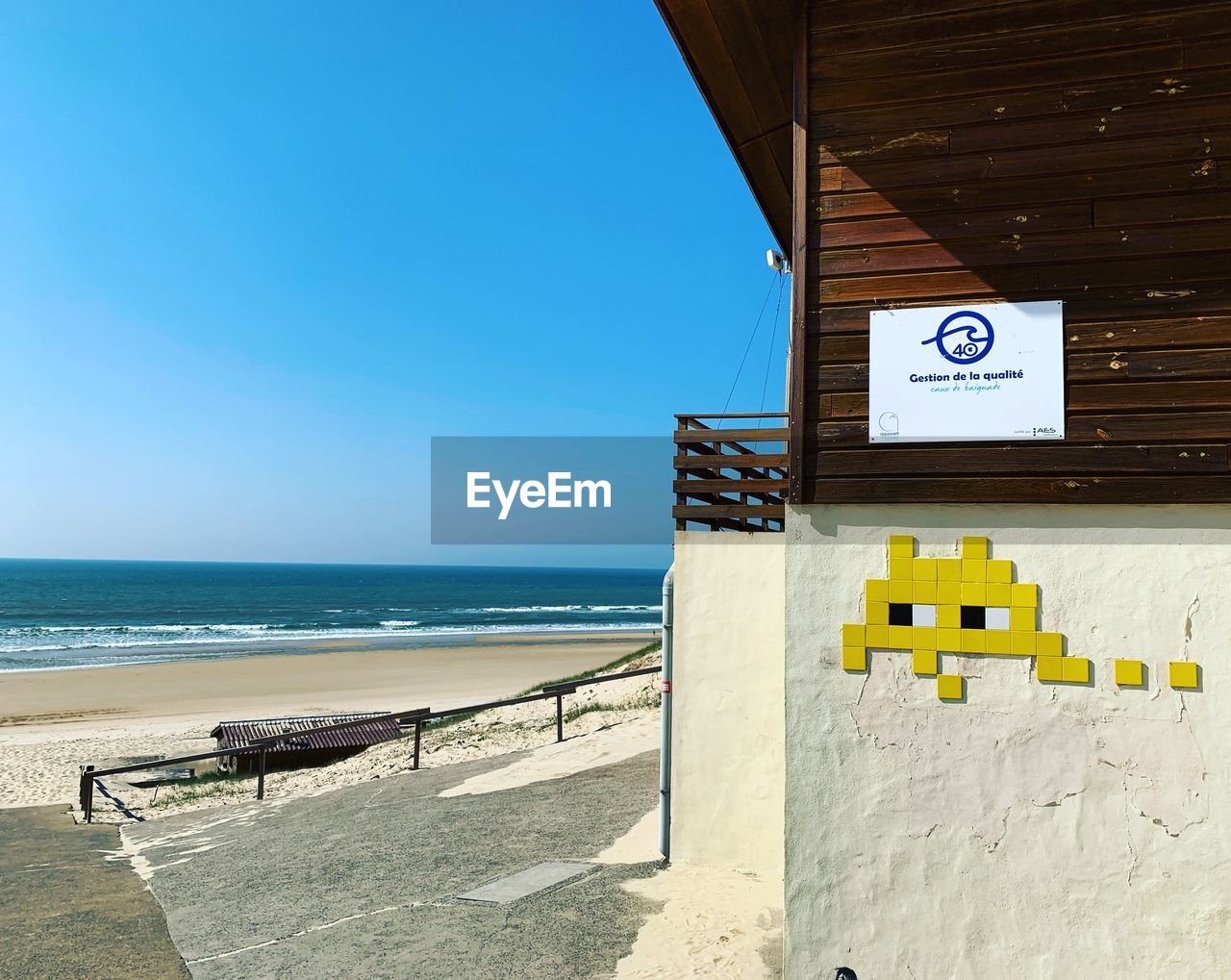 INFORMATION SIGN ON BEACH AGAINST SKY