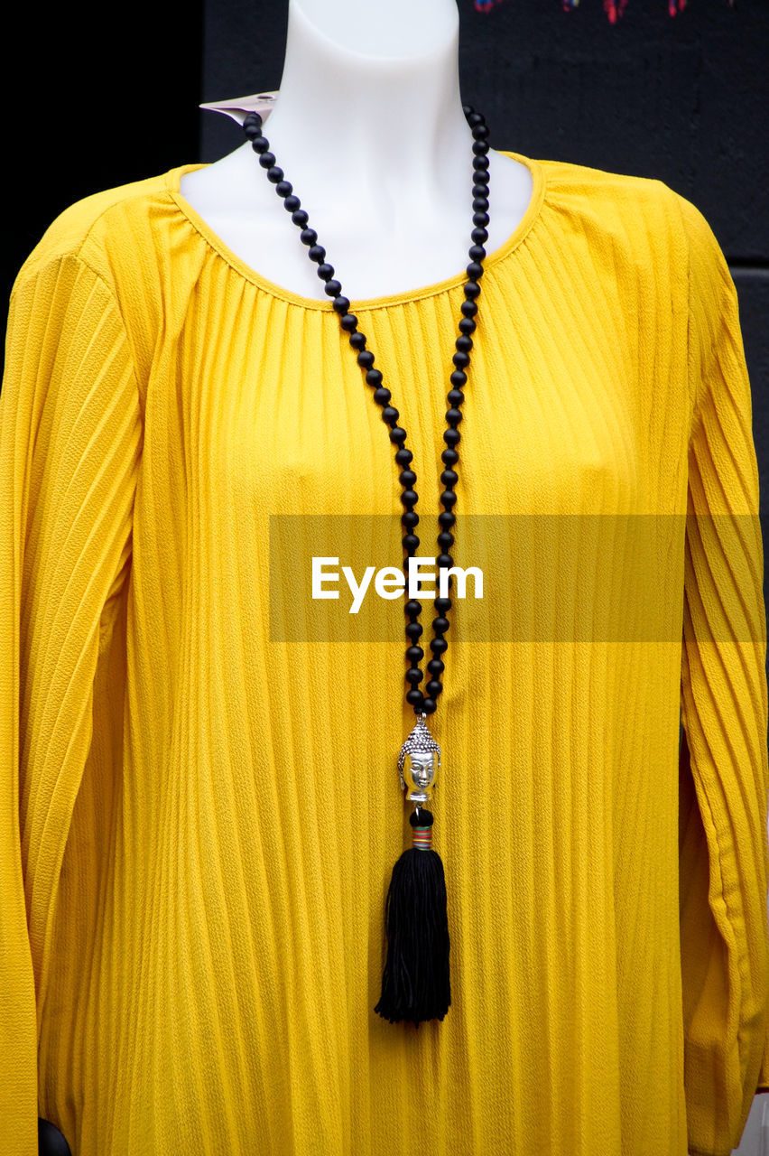 Close-up of yellow clothing in mannequin