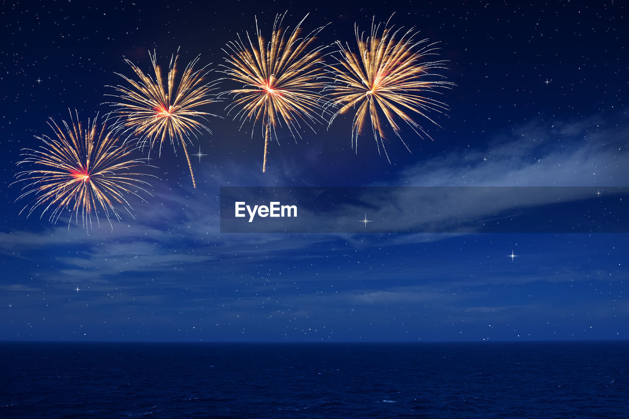 FIREWORK DISPLAY IN SEA AT NIGHT