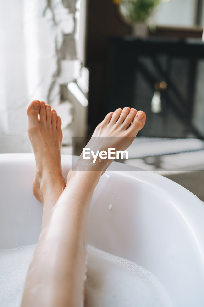 Young happy woman taking bath at home, treat yourself