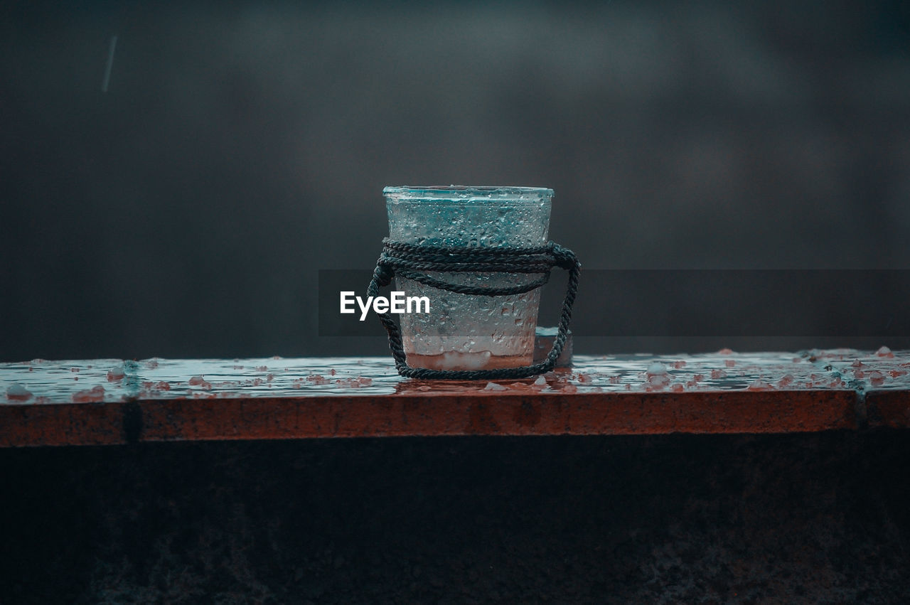 Close-up of glass on wet table during rainy season