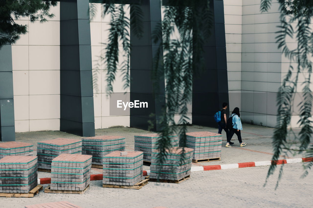 People walking by building in city