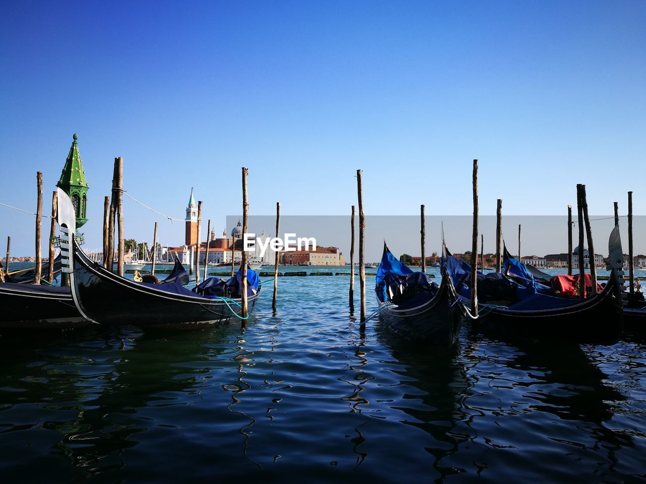 BOATS MOORED ON WOODEN POST