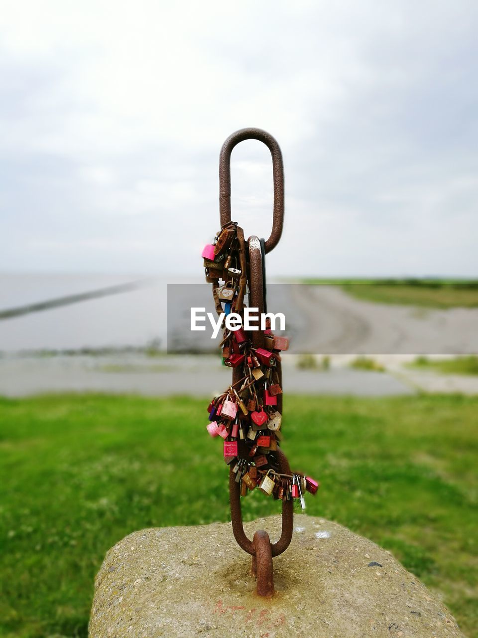 Love padlocks locked on rock near by lake