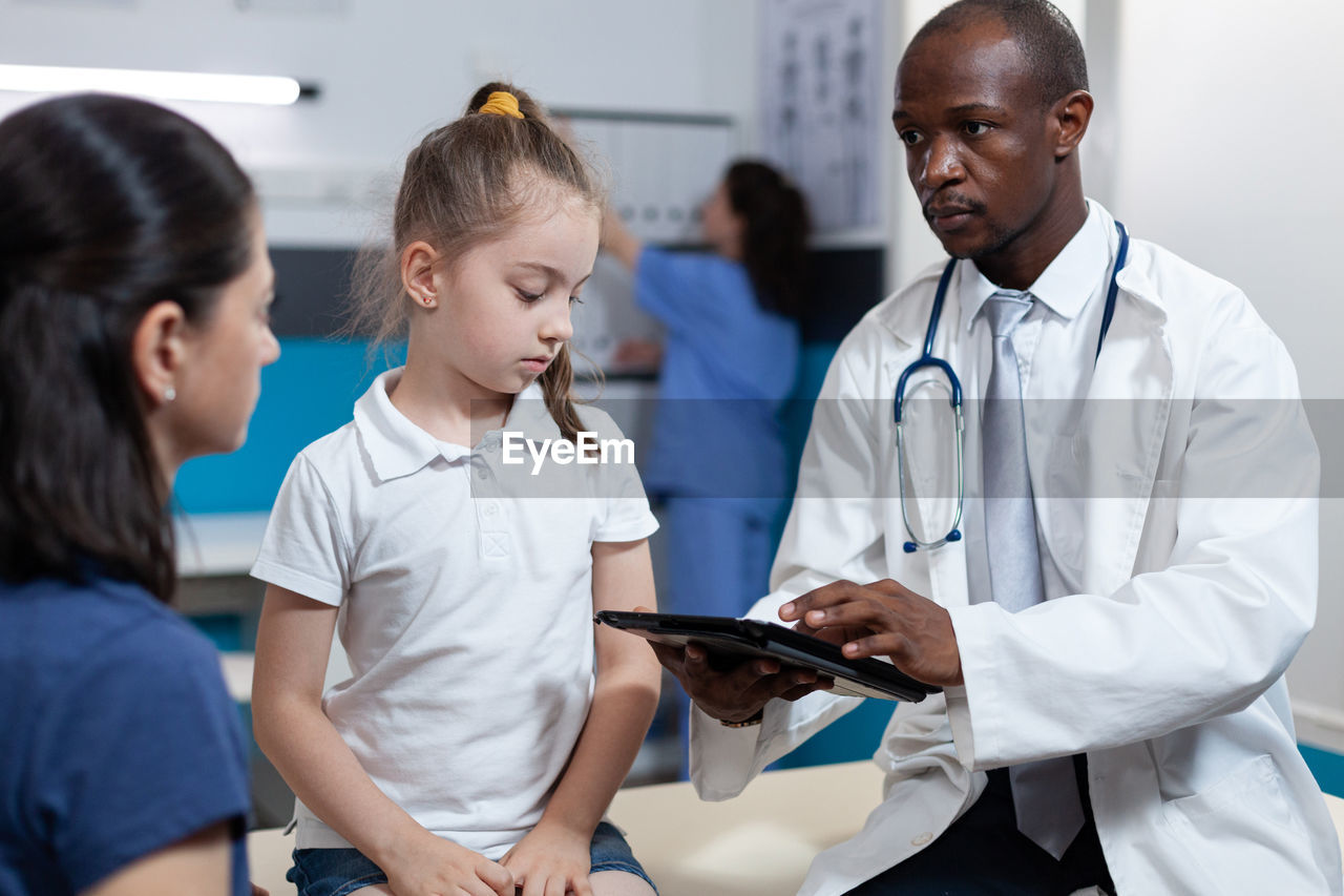 side view of doctor examining patient in hospital