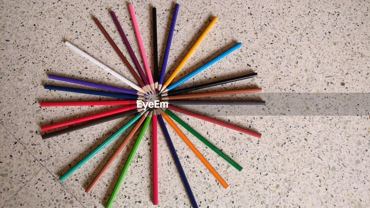Directly above shot of colored pencils arranged on floor