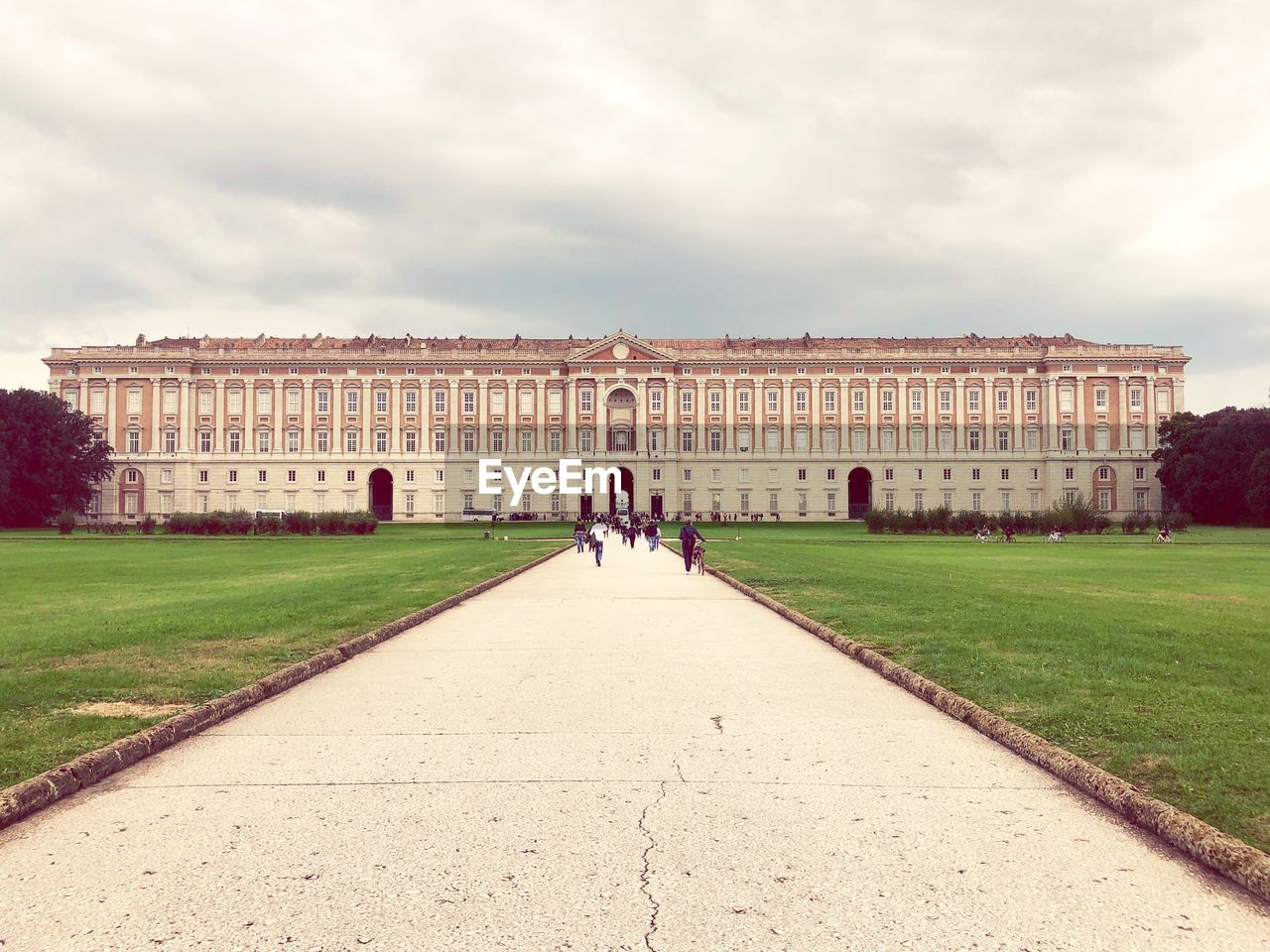 WOMAN WALKING IN FRONT OF HISTORICAL BUILDING