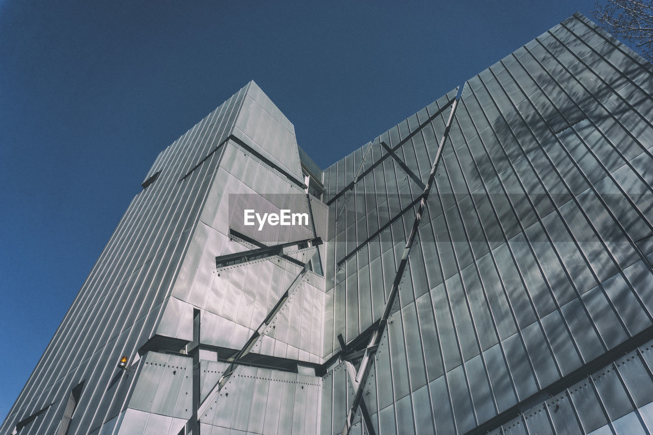 Low angle view of building against clear blue sky during sunny day