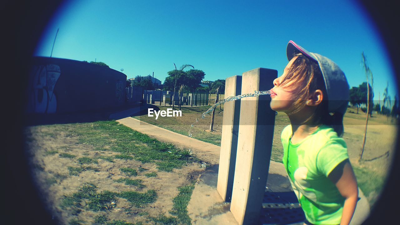 Girl spitting water at park